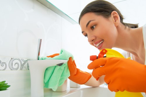 Professional cleaner in Docklands maintaining a modern apartment