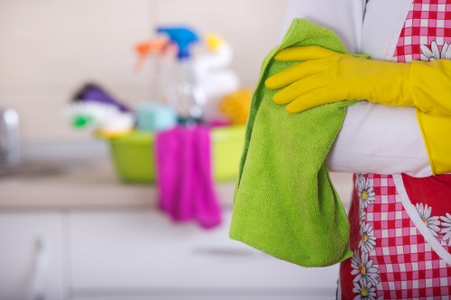 Cleaner removing dirt from large Docklands apartment windows
