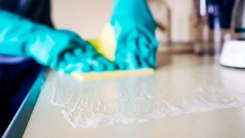 Cleaner wearing PPE during professional carpet cleaning
